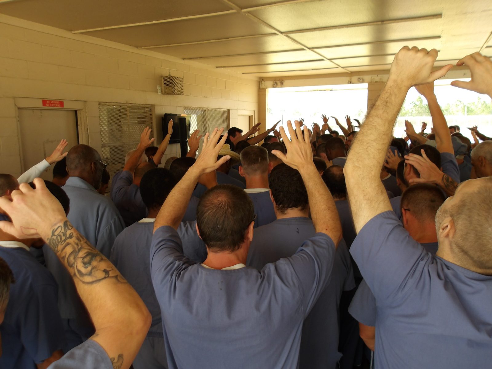 Inmates raising their hands in worship