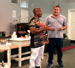 James sharing his testimony at church